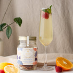 Load image into Gallery viewer, Amalfi afternoon cocktail infusion kit and a tall glass with the cocktail, a raspberry  and some menta leaves
