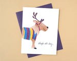 Load image into Gallery viewer, Card with a reindeer wearing a colourful sweater and 'sleigh all day' text on a beige background
