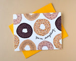 Load image into Gallery viewer, Card with bagel design and text 'You're everything' on a beige background
