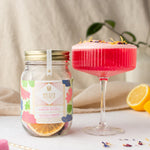 Load image into Gallery viewer, Hawaiian hibiskiss cocktail kit jar with a tall round glass with the pink cocktail
