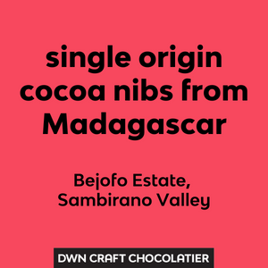 Text on a red background about single origin cocoa nibs from Madagascar with DWN Craft Chocolatier branding.