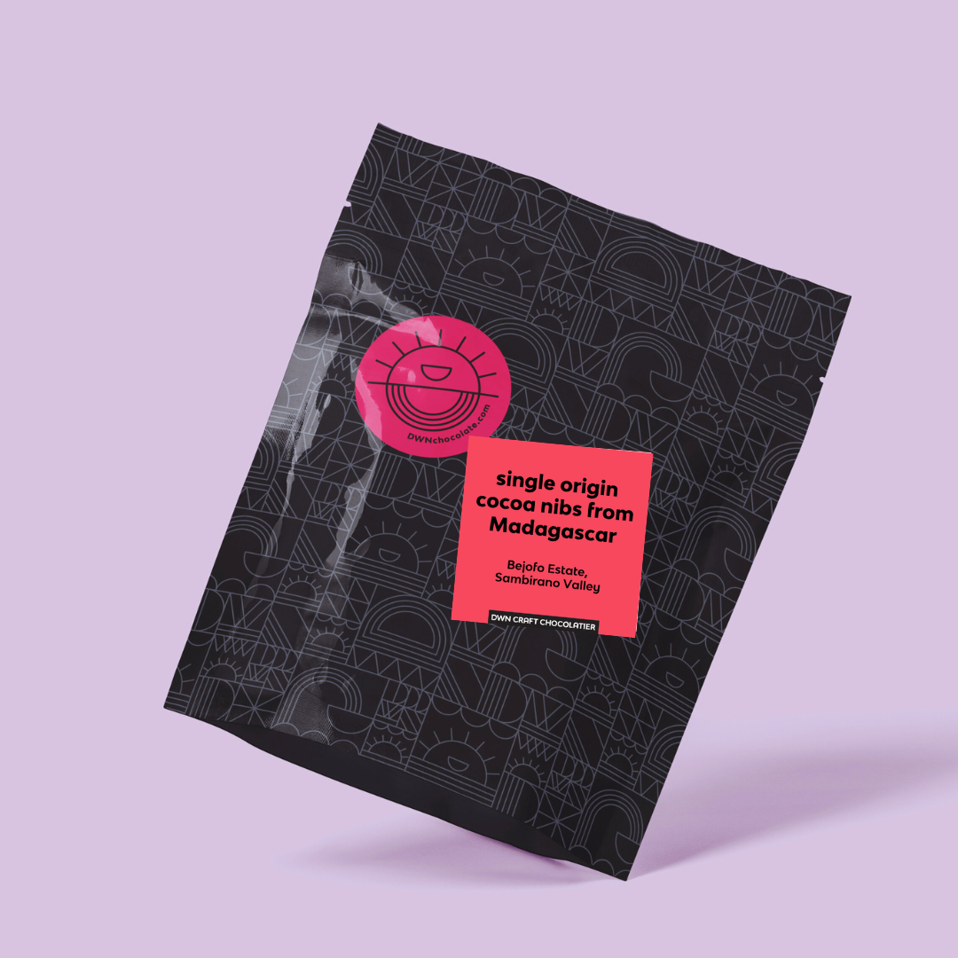 black packaging with pink labels on a light purple background