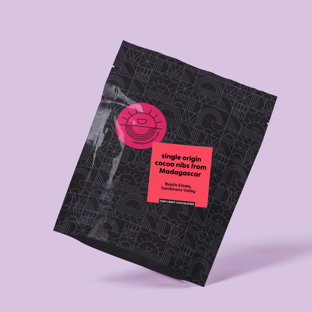 black packaging with pink labels on a light purple background