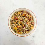 Load image into Gallery viewer, Dried citrus tea leaves in a white bowl on a marble surface
