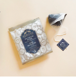 Load image into Gallery viewer, Sloane signature black tea pouch beside its package on a light peach background
