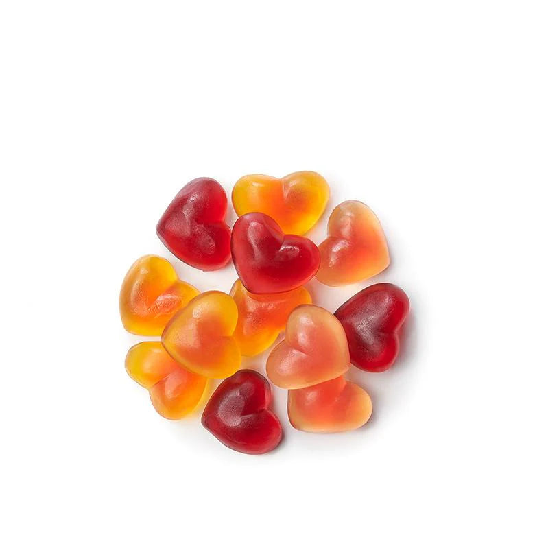 Heart-shaped gummy candies in red, orange, and yellow on a white background