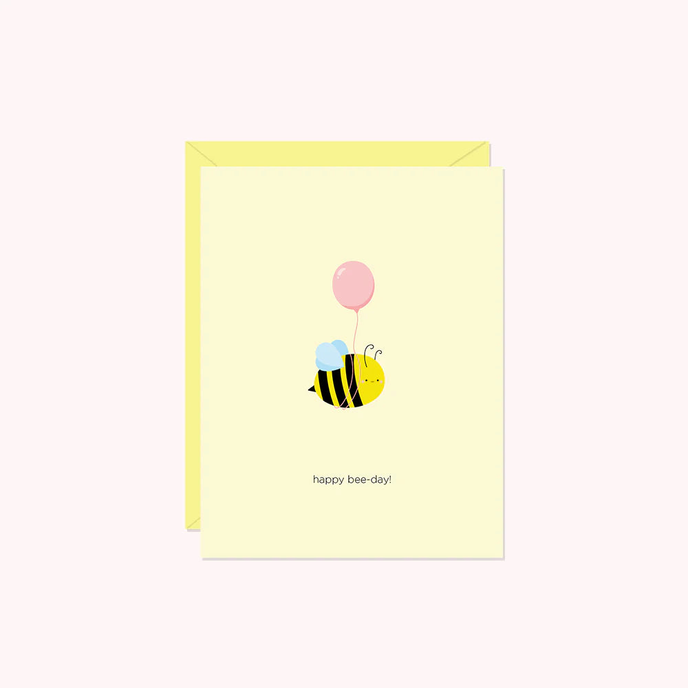a bee wearing a balloon with the message "happy bee-day!"