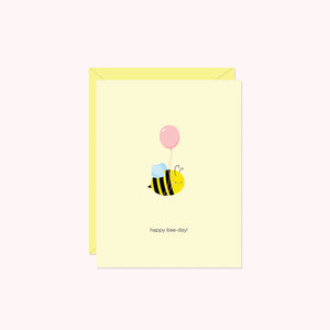 a bee wearing a balloon with the message "happy bee-day!"