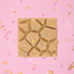 Load image into Gallery viewer, birthday cake bar with colourful sprinkles on a pink background
