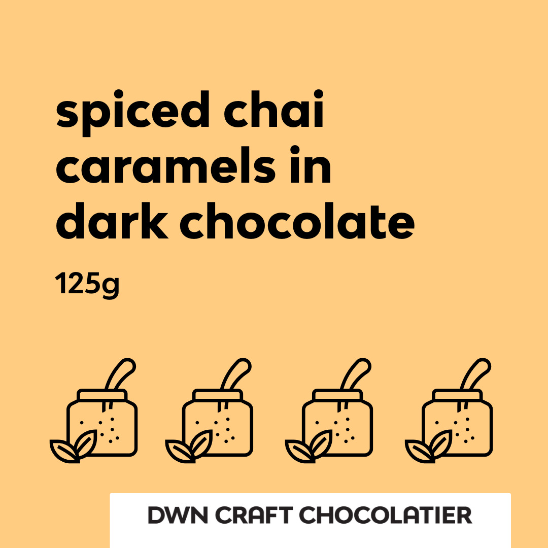 yellow background with text that reads, "spiced chai caramels in dark chocolate"
