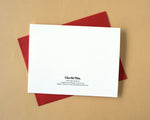 Load image into Gallery viewer, White card back with text on a red envelope against a beige background
