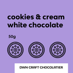 Load image into Gallery viewer, label for cookies &amp; cream white chocolate with DWN Craft Chocolatier branding on a purple background.
