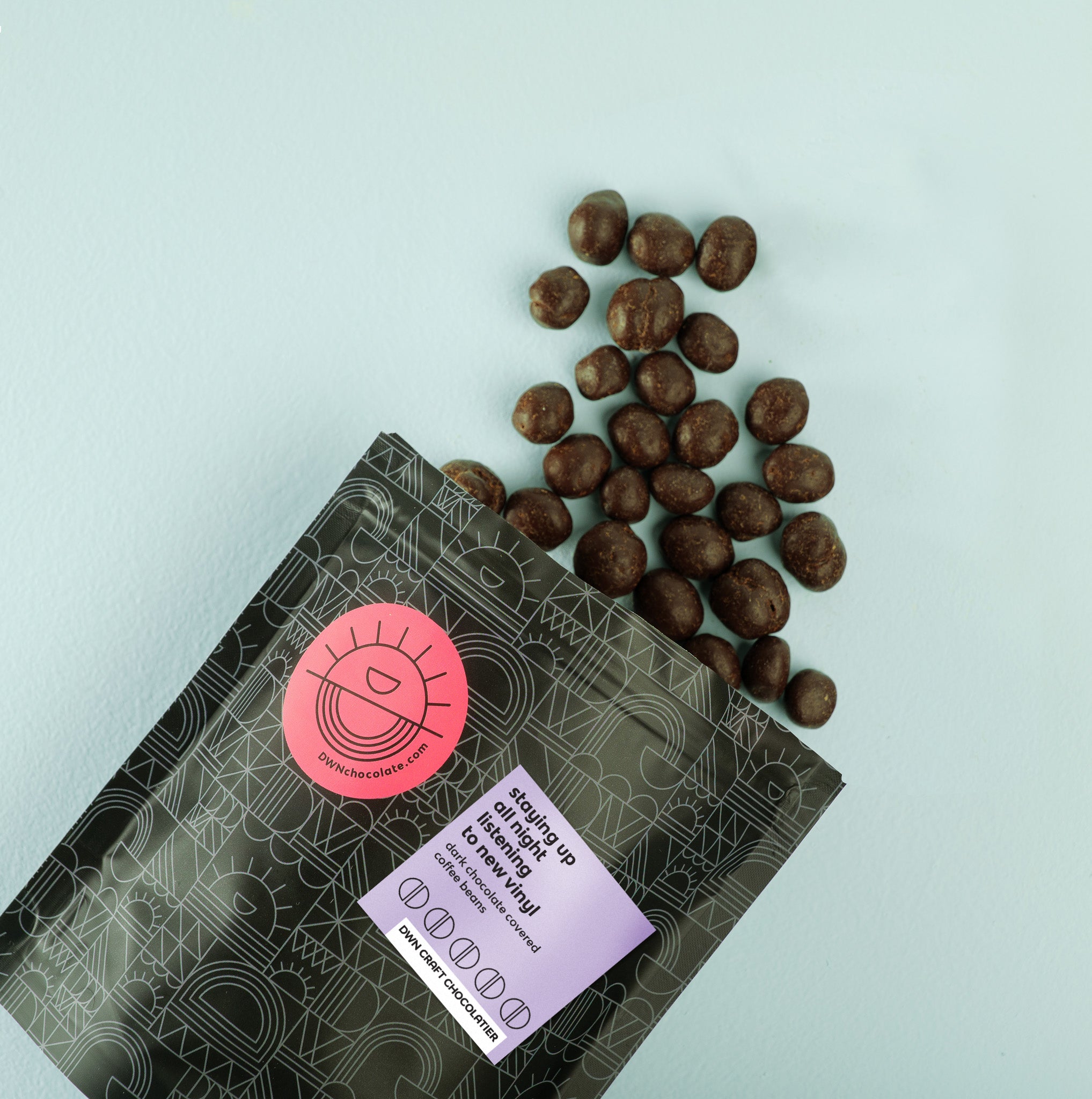 dark chocolate coffee beans tumbling out of a pouch