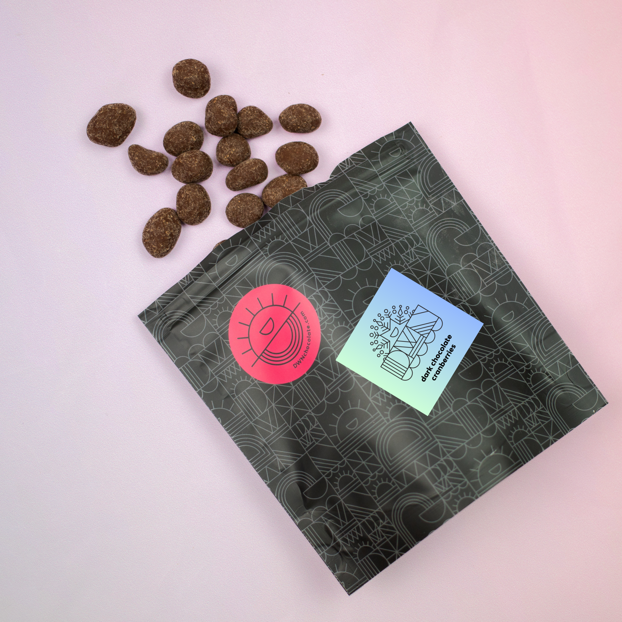 overhead photo of an opened package of dark chocolate cranberries tumbling out of the package