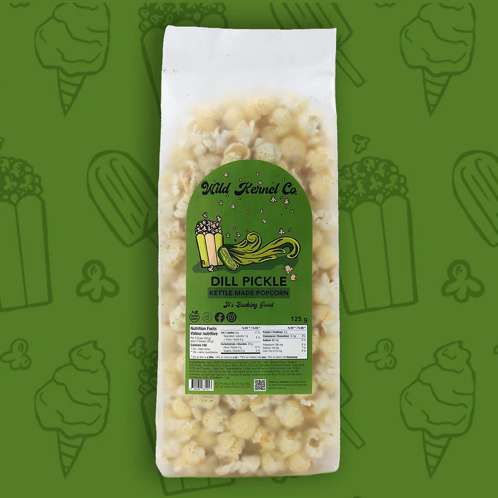 Packaged dill pickle popcorn with a green label on a green background with corn illustrations.