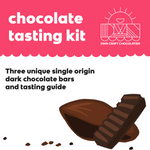 Load image into Gallery viewer, the front page of the chocolate tasting guidebook with text that reads, &quot;chocolate tasting kit. three unique single origin dark chocolate bars and tasting guide&quot;
