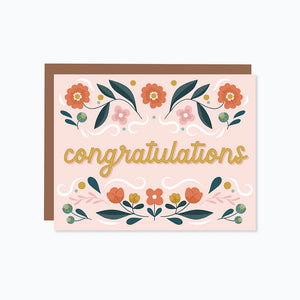 floral border on the top and bottom with the word congratulations in the middle