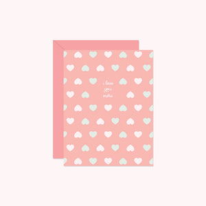 Pink card with heart patterns and text on a white background