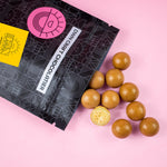 Load image into Gallery viewer, lemon meringue malt balls falling out of the package
