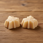 Load image into Gallery viewer, two pieces of maple candy on a wood background

