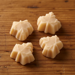 Load image into Gallery viewer, four pieces of maple candy on a wood background
