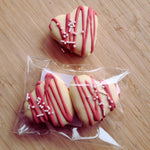 Load image into Gallery viewer, strawberry marshmallow coated in white chocolate; one single and two in packaging
