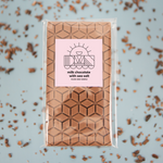 Load image into Gallery viewer, milk chocolate bar with sea salt in its package
