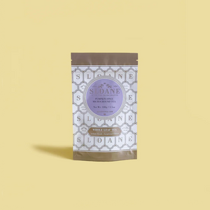 tea pouch with a geometric pattern and purple label on a yellow background