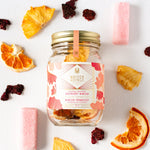 Load image into Gallery viewer, raspberry mimosa cocktail infusion kit jar among slices of dried oranges and pineapple
