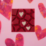 Load image into Gallery viewer, raspberry toffee bar on pink background with heart patterns

