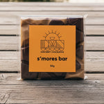 Load image into Gallery viewer, s'mores bar chocolate wrapped in clear plastic with a bright orange label
