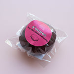 Load image into Gallery viewer, S'mores hot chocolate meltaway in clear packaging on a pink background
