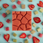 Load image into Gallery viewer, strawberry rhubarb chocolate bar on a bed of strawberry and rhubarb fruit pieces
