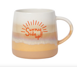 Load image into Gallery viewer, cream stoneware mug with a warm, layered glaze in beige, peach, and golden yellow, featuring the orange “Sunny Side Up!” lettering surrounded by sunburst rays
