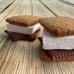 Load image into Gallery viewer, two assembled s&#39;mores on a picnic table
