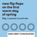 Load image into Gallery viewer, Label for coconut crunch bar has light blue background and black text that reads, &quot;new flip flops on the first warm day of spring. 80g / coconut crunch bar. DWN Craft Chocolatier&quot;
