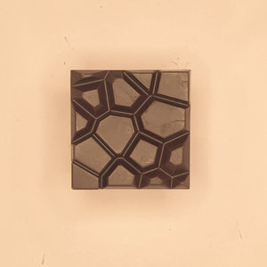 a spiced coconut cashew bar lies on an orange background
