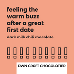 Load image into Gallery viewer, orange background with black text that reads; feeling the warm buzz after a great first date. dark milk chili chocolate.
