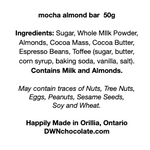 Load image into Gallery viewer, black text on a white background that reads, mocha almond bar 50g Ingredients: Sugar, Whole MIlk Powder, Almonds, Cocoa Mass, Cocoa Butter, Espresso Beans, Toffee (sugar, butter, corn syrup, baking soda, vanilla, salt). Contains Milk and Almonds. May contain traces of Nuts, Tree Nuts, Eggs, Peanuts, Sesame Seeds, Soy and Wheat. Happily Made in Orillia, Ontario DWNchocolate.com&quot;
