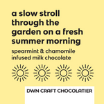 Load image into Gallery viewer, yellow background with black text that reads, &quot;a slow stroll through the garden on a fresh summer morning. spearmint &amp; chamomile infused milk chocolate&quot;
