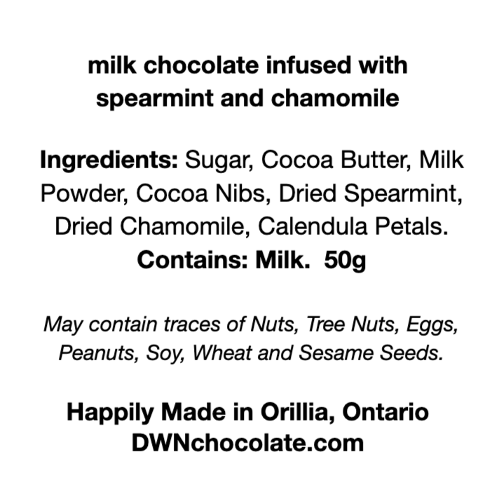 black text on a white background that reads, "milk chocolate infused with spearmint and chamomile  Ingredients: Sugar, Cocoa Butter, Milk Powder, Cocoa Nibs, Dried Spearmint,  Dried Chamomile, Calendula Petals. Contains: Milk.  50g  May contain traces of Nuts, Tree Nuts, Eggs, Peanuts, Soy, Wheat and Sesame Seeds. Happily Made in Orillia, Ontario DWNchocolate.com"